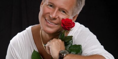 Artysta Jacek Silski z różą w dłoni